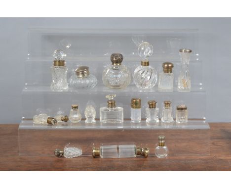 A large collection of silver and silver plate-topped perfume/scent bottles,&nbsp; comprising eleven hallmarked silver topped 