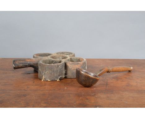 A 19th century far Indian primitive treen spice holder, with wear and traces of historic woodworm 25cm in length, together wi