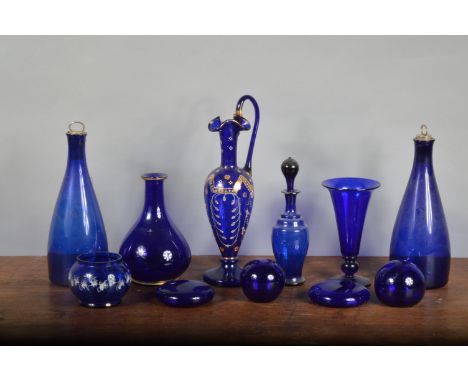 An assorted collection of Bristol Blue glass, 19th century and later, including a claret jug with stopper, heightened gilt an