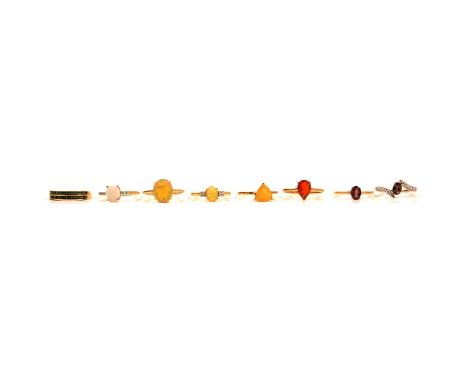 Eight gemset gold rings, Ethiopian opal, fire opal, colour change garnet, an Ethiopian opal ring, in a 14 carat yellow gold m