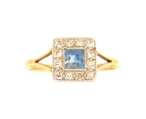 A sapphire and diamond cluster ring, a square cut sapphire surrounded by twelve 8 cut diamonds in a 9.5mm square yellow and w