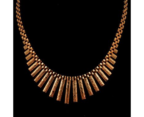 A 1970's vintage 9 carat yellow gold fringe necklace, bark textured bars graduating from 20mm to 2mm, on a 3 link wide neckla