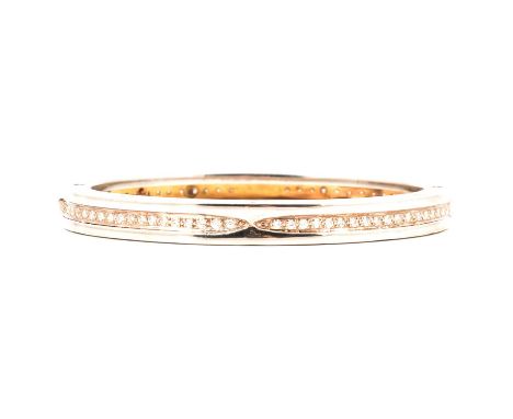 Bvlgari - A b.zero1 steel and gold bangle aftermarket set with diamonds, the 7mm wide half hinged bangle set with seventy-one