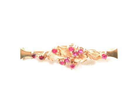 A ruby set bar brooch, a 9 carat 50mm leaf design bar brooch claw set with ten rubies, hallmarked Birmingham 1984, 4g.