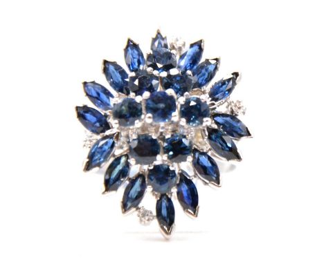 A synthetic sapphire and diamond dress ring, the nine brilliant and sixteen marquise cut synthetic sapphires with four brilli