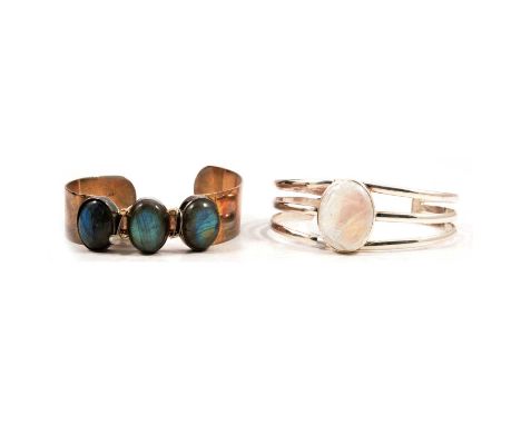 A moonstone bangle and a labradorite bangle, a moonstone bangle, the oval cabochon cut moonstone collet set to a silver taper