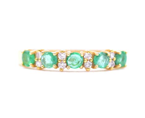 An emerald and diamond half eternity ring, five 3mm circular faceted emeralds spaced by four pairs of brilliant cut diamonds 