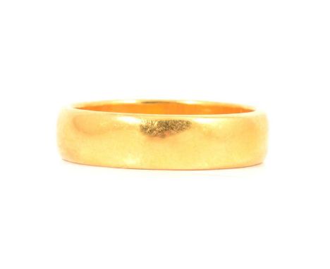 A 22 carat yellow gold wedding band, 5.2mm wide plain polished half D shape band ring size O, Birmingham 1989, 7g.