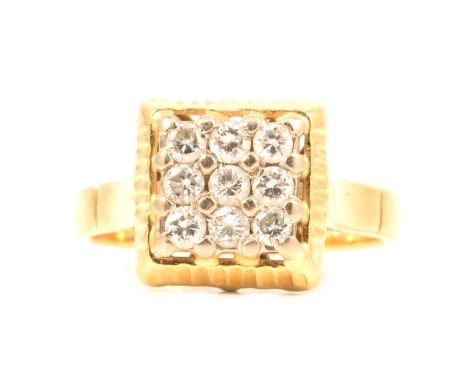 A diamond cluster ring, the nine brilliant cut stones claw set into the 11.2mm square head in an 18 carat yellow gold mount r