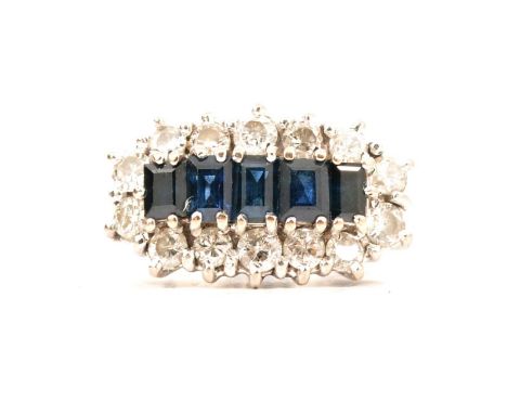 A sapphire and diamond cluster ring, five rectangular sapphires claw set horizontally and surrounded by fourteen brilliant cu