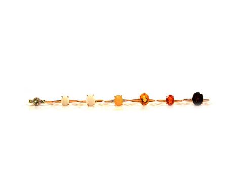 Seven gemset gold rings, ultraviolet colour change garnet, Coober Pedy opal and others, an ultraviolet colour change garnet a