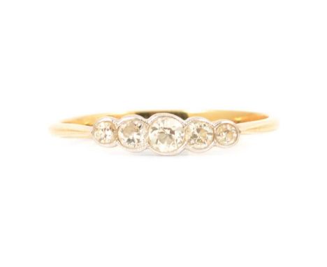 A diamond five stone ring, the five old brilliant cut graduated stones collet set in a yellow and white metal mount ring size