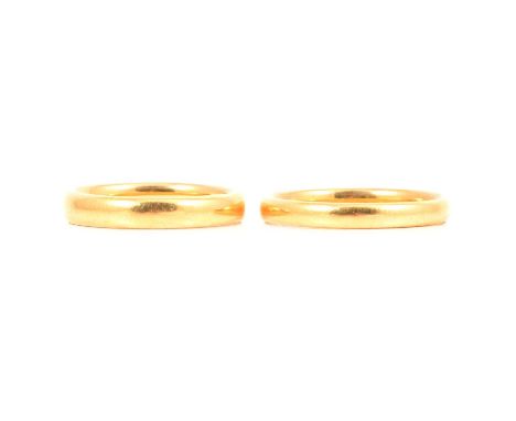 Two 22 carat yellow gold wedding bands, a 22 carat yellow gold wedding band, 3.8mm wide plain polished D-shape band ring size