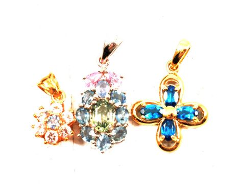 Seven gemset pendants, opal, ruby, blue topaz and others, an opal and ruby pendant; a blue topaz pendant; a rock crystal quar