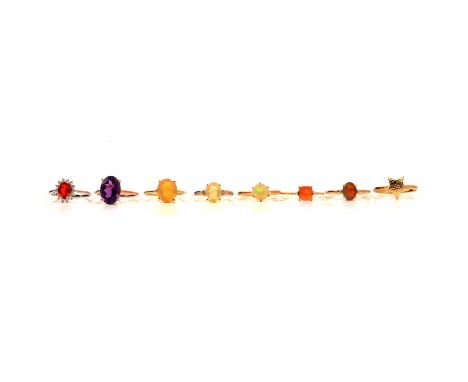 Eight gold rings, Ethiopian opal, fire opal and others, to include an Ethiopian opal ring, in a 9 carat yellow gold mount rin