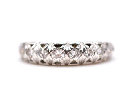 A diamond half eternity ring, the fifteen brilliant cut graduated stones collet set in a 5.4mm wide 18 carat all white gold m