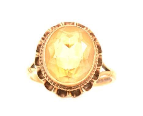 Two gemset rings, citrine and iolite, a citrine solitaire ring, the mixed cut citrine collet set with a rope and frill border