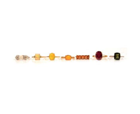 Seven gemset gold rings, garnet, moldavite, Coober Pedy opal, Ethiopian opal and others, a Kurundu garnet ring, in a 9 carat 