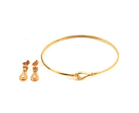 A diamond set bangle and earring set, the 9 carat yellow gold bangle with a brilliant cut diamond set to the hook part of a h