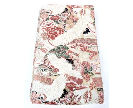 A Japanese silk obi sash, 20th century, woven with herons above buildings and landscapes, length 4m approx x 31cm