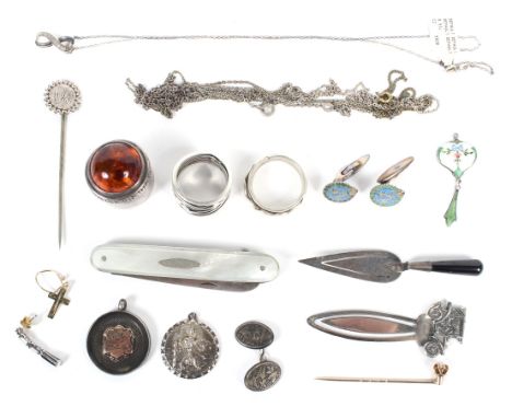 A collection of 20th Century silver collectables, including a mother of pearl fruit knife, two novelty bookmarks, two rings, 