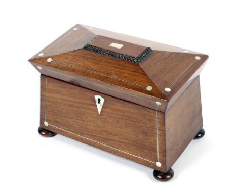 A Victorian mahogany tea caddy, of sarcophagus form, with inlaid mother of pearl decoration and escutcheon, containing two co