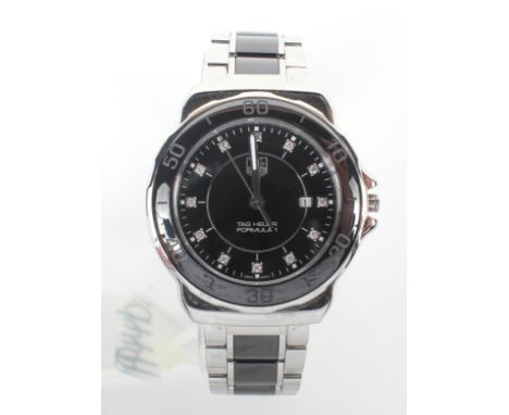 A stainless steel and black ceramic Tag Heuer formula 1 quartz watch. 30.0mm case with black diamond dot dial and date featur