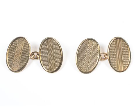A yellow metal pair of chain link cufflinks with oval terminals having engine turned design. Hallmarked 9ct gold. 5.0 grams