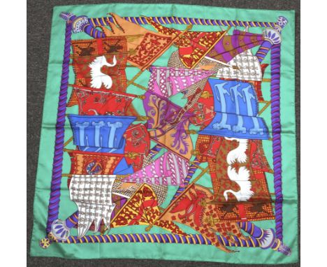A contemporary Hermes silk scarf, 'Flags and Banners' on a green ground, 90cm x 90cm