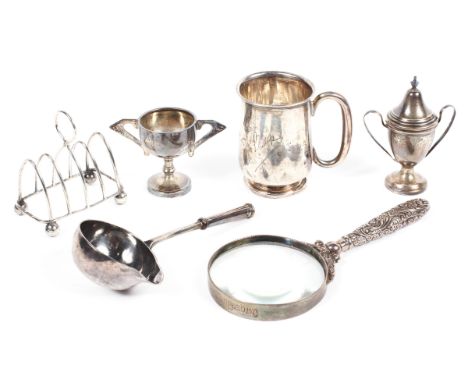 A selection of silver wares, comprising a Georgian toddy ladle bowl, four slice toast rack,a mug and two small trophies, comb