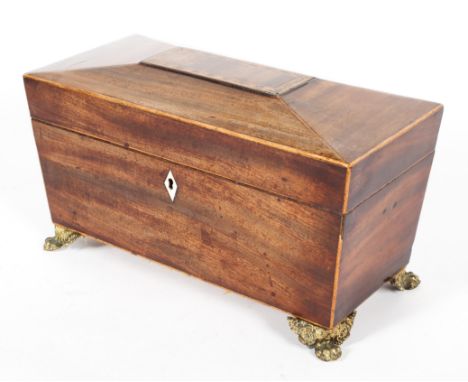 A George III mahogany gilt-metal mounted tea caddy, of sarcophagus form, the top inlaid with geometric ornament, the interior