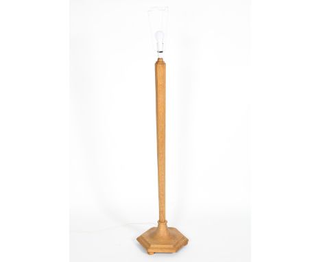 A 20th century oak standard lamp, in the arts and crafts style, of tapering hexagonal form, 126cm high (excluding fittings)