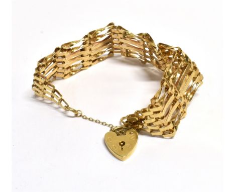 9CT GOLD SIX BAR GATE BRACELET18cm long, 2cm wide, consisting of six alternating flat and twisted bars, with heart shaped pad