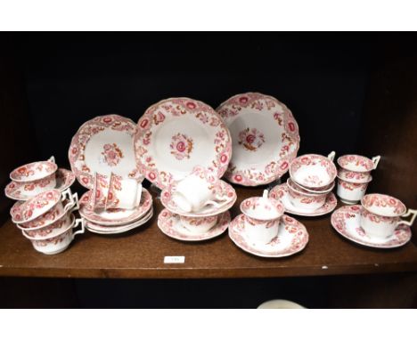A Victorian porcelain part tea service on white ground and decorated with repeating floral motifs