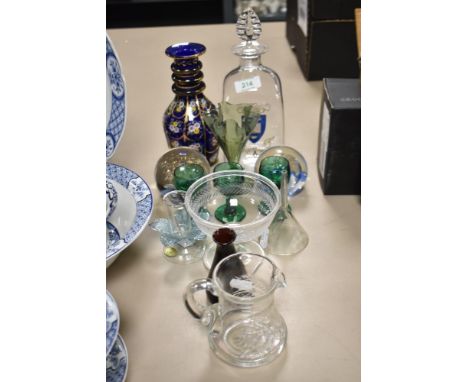 A mixed lot of vintage glass, including paperweights, fine green glass fluted bud vase, decanters and glass funnel.