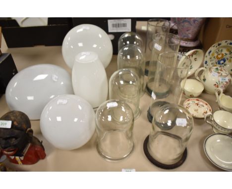 A collection of vintage glass light shades and chimneys.