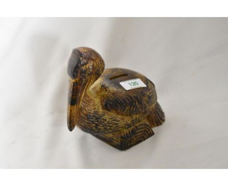 A vintage ceramic money box in the form of a Pelican.