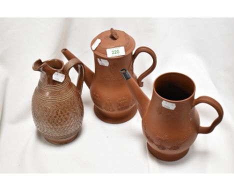 A 19th century embossed earthenware coffee pot with raised hunting scene, a similar styled teapot with floral swag decoration