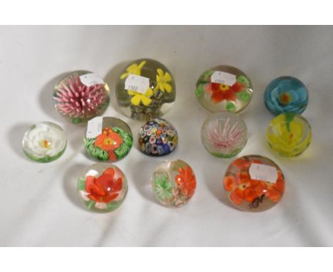 A collection of vintage floral paperweights and one Milliefiori.
