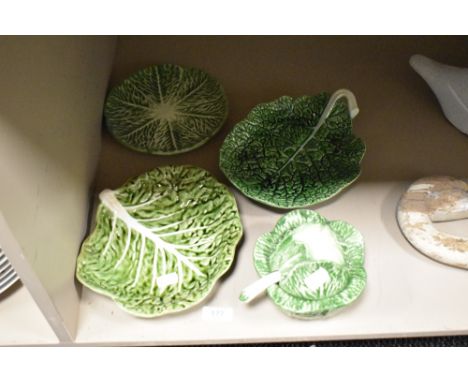 A small group of naturalistically moulded cabbage leaf design items, plates, dish and sauce tureen and ladle