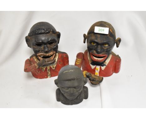 Three vintage cast metal articulated money boxes.