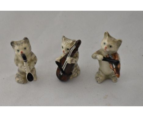 Three Vintage Beswick pottery cats, all playing musical instruments.