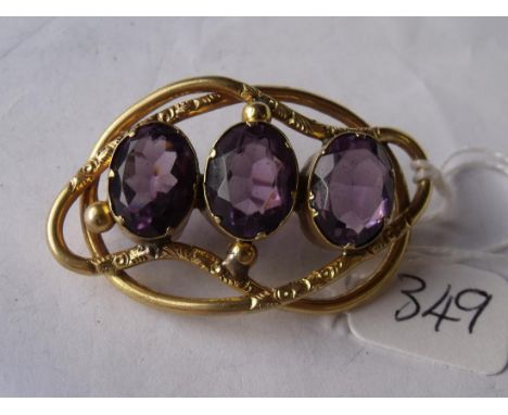 A large antique gold brooch set with three substantial  amethyst stones  11.8g inc      