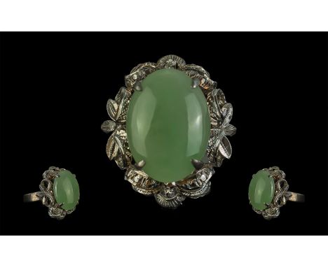 18ct White Gold Dress Ring, Set With On Oval Jade Stone In A Floral Mount, Stamped 18k, Ring Size O, Gross Weight 7.5 grams