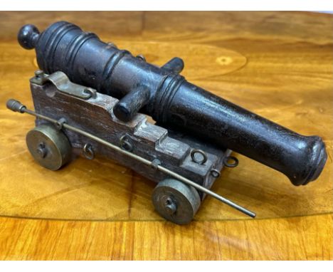 Model Field Cannon, bronzed gun on an oak carriage with brass wheels and mounts, and a ramrod.  Cannon length 10.5".