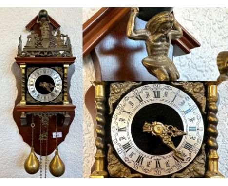Antique Cuckoo Clock, Roman numerals, brass weights, brass twist supports, top depicting a figure of Atlas surrounded by carv