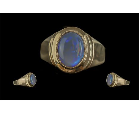 A Fine 14ct Gold Single Stone Opal Set Ring of Oval Form. Marked 14ct to Shank. The Opal of Blue, Purple, Orange and Green Co