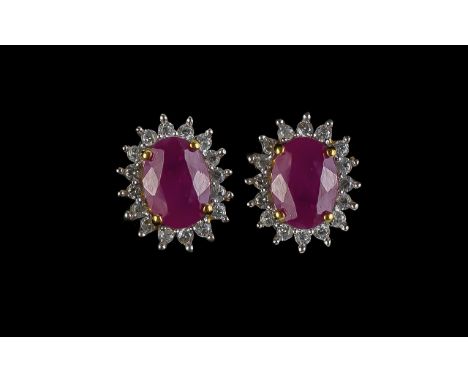 Ruby Halo Stud Earrings, each of the two oval cut, rich red, rubies of 1.5cts, framed with a halo of sparkling, clear, natura