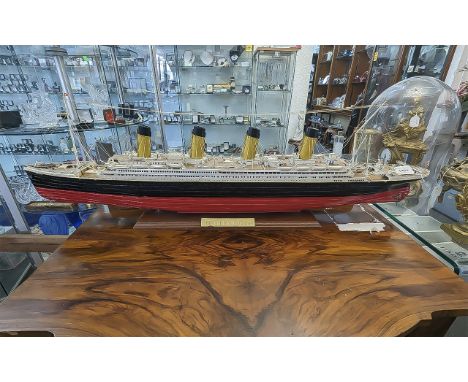 Scratch Built Model of the Titanic, mounted on a wooded base with plaque to front.  Measures 43'' wide.