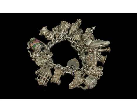 A Vintage - Excellent and Heavy Sterling Silver Curb Bracelet - Loaded with 25 Large Sterling Silver Charms of Good Quality. 